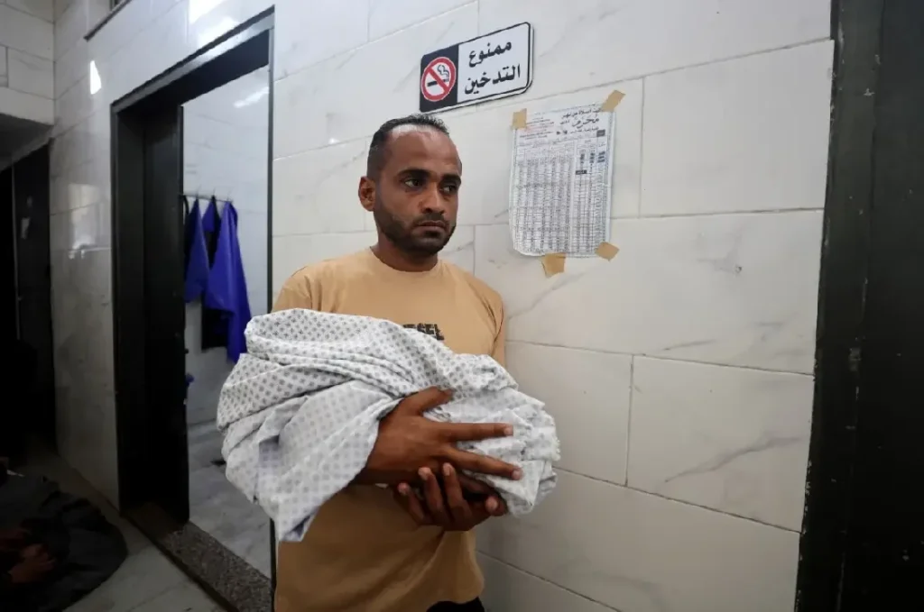 Palestinian Father carrying baby's dead body